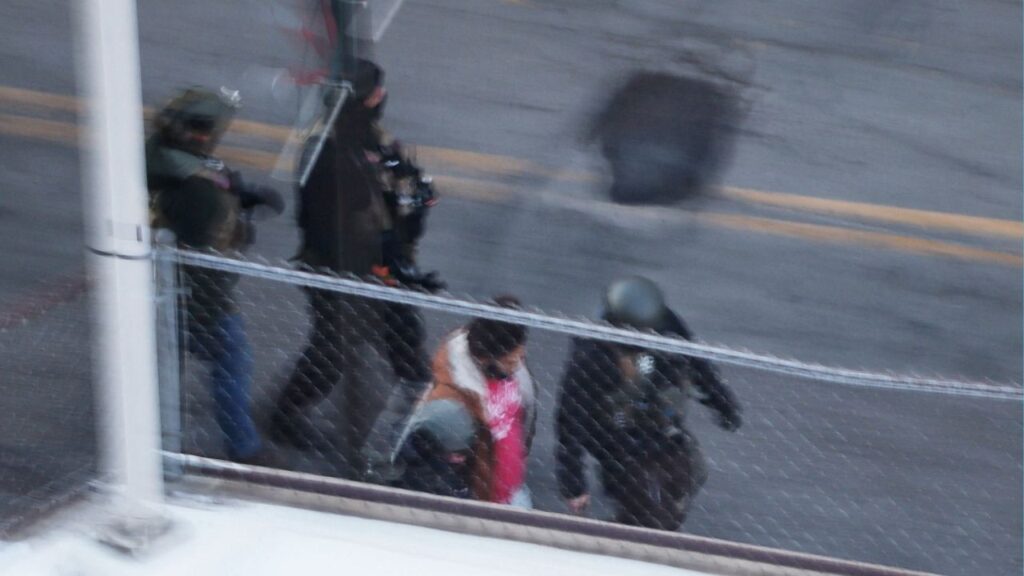 Federal immigration enforcement agents detain a person from an apartment building, days after a man identified as Alex Pretti was fatally shot by federal immigration agents trying to detain him, in Minneapolis, Minnesota, U.S., January 28, 2026. (Reuters/Brian Snyder)