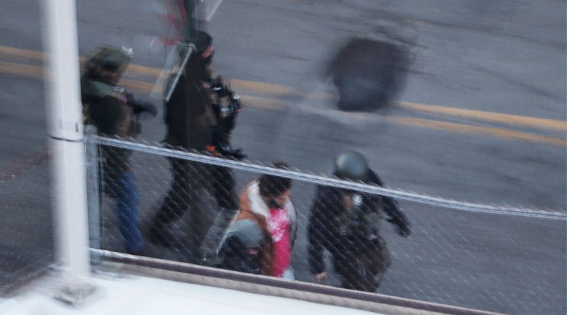 Federal immigration enforcement agents detain a person from an apartment building, days after a man identified as Alex Pretti was fatally shot by federal immigration agents trying to detain him, in Minneapolis, Minnesota, U.S., January 28, 2026. (Reuters/Brian Snyder)