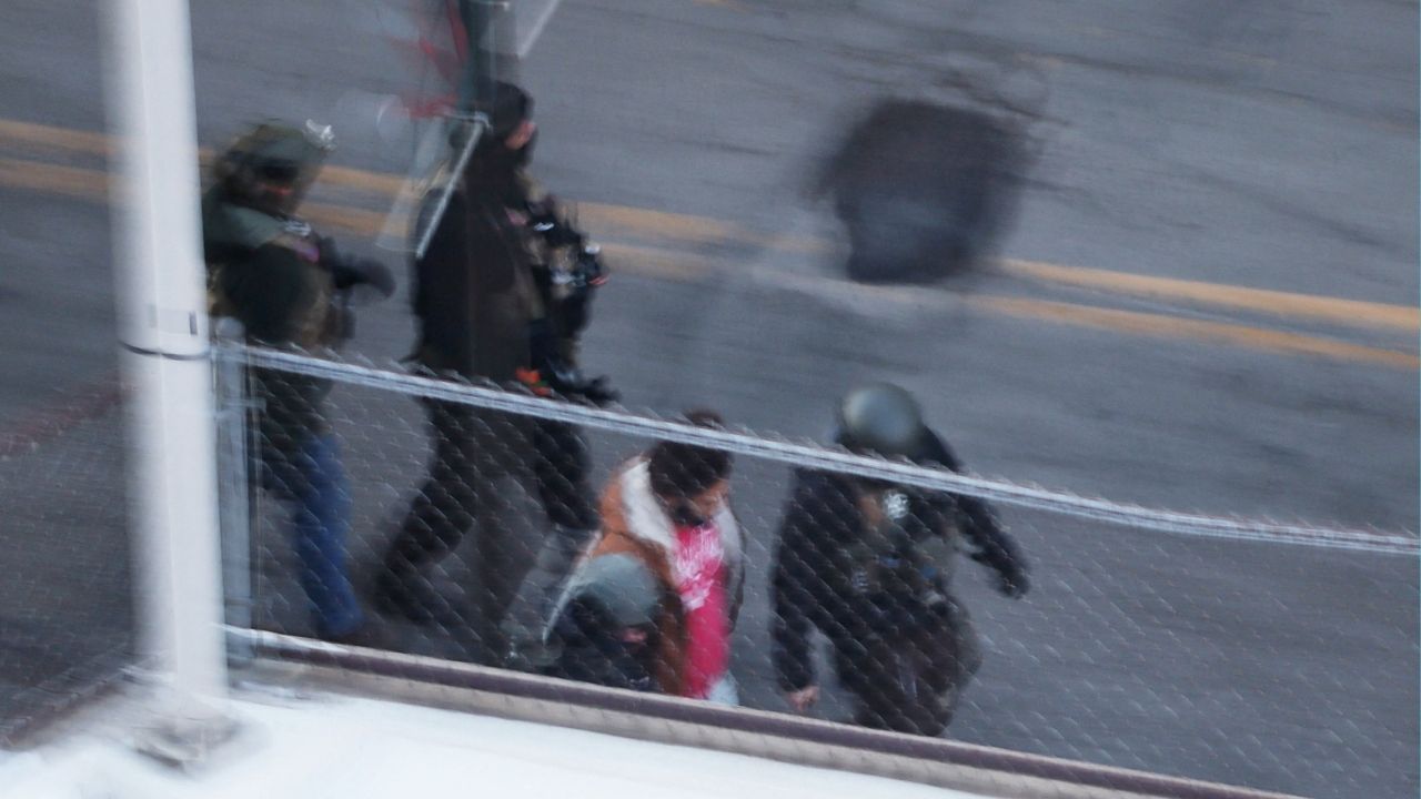Federal immigration enforcement agents detain a person from an apartment building, days after a man identified as Alex Pretti was fatally shot by federal immigration agents trying to detain him, in Minneapolis, Minnesota, U.S., January 28, 2026. (Reuters/Brian Snyder)