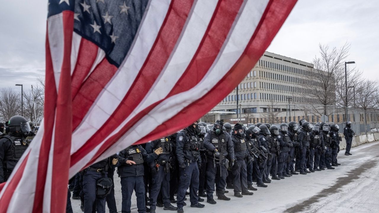 Federal officers face off against protesters outside the Whipple Federal Building in Minneapolis on Thursday, Jan. 15, 2026. The Pentagon has ordered several hundred active-duty military police troops from Fort Bragg, N.C., to prepare for a possible deployment to Minnesota in the event that President Trump invokes the Insurrection Act, according to a senior U.S. official. (David Guttenfelder/The New York Times)