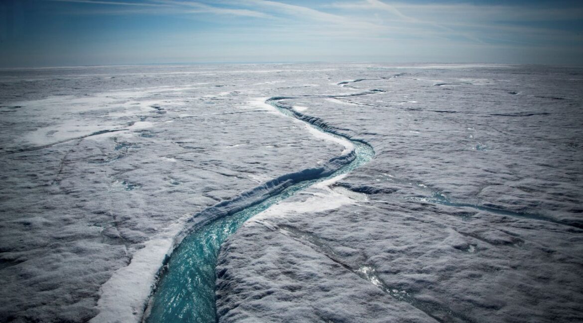 Image of glacial melt forming a river flowing atop the Greenland Ice Sheet