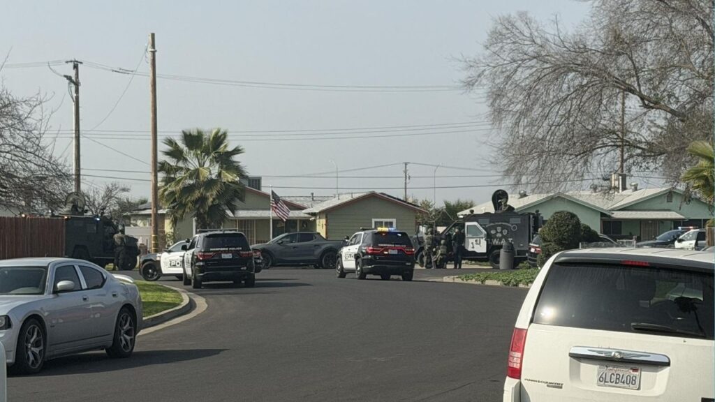 Hanford police and SWAT officers on Friday, Jan. 30, 2026, surrounded a home on Ogden Street after suspects shot and killed a 17-year-old at the Casa Del Sol Apartments earlier in the day. (City of Hanford)