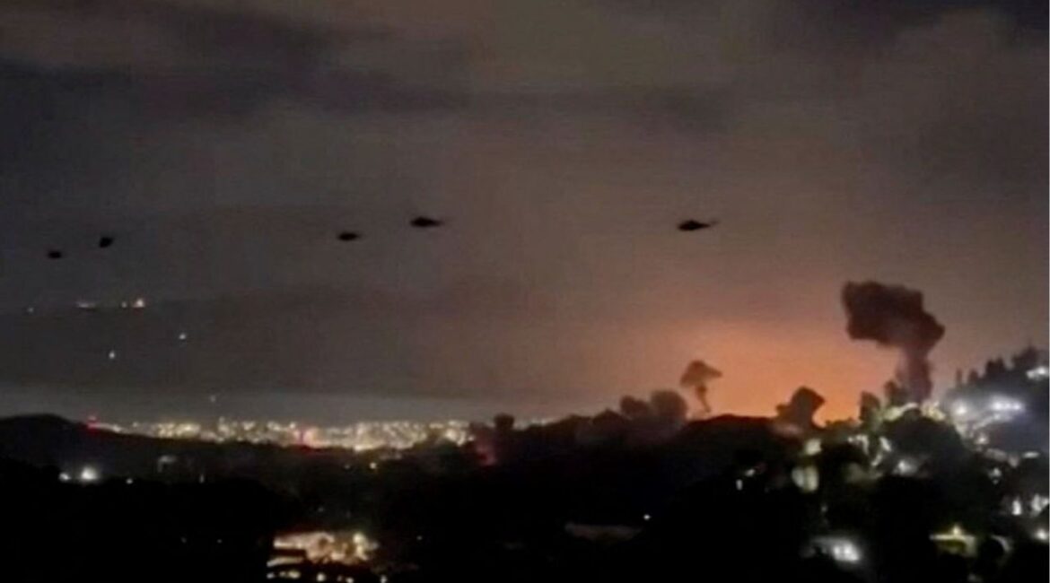 Helicopters fly past plumes of smoke rising from explosions, in Caracas, Venezuela, January 3, 2026 in this screen grab obtained from video obtained by Reuters. Video Obtained by Reuters/via REUTERS