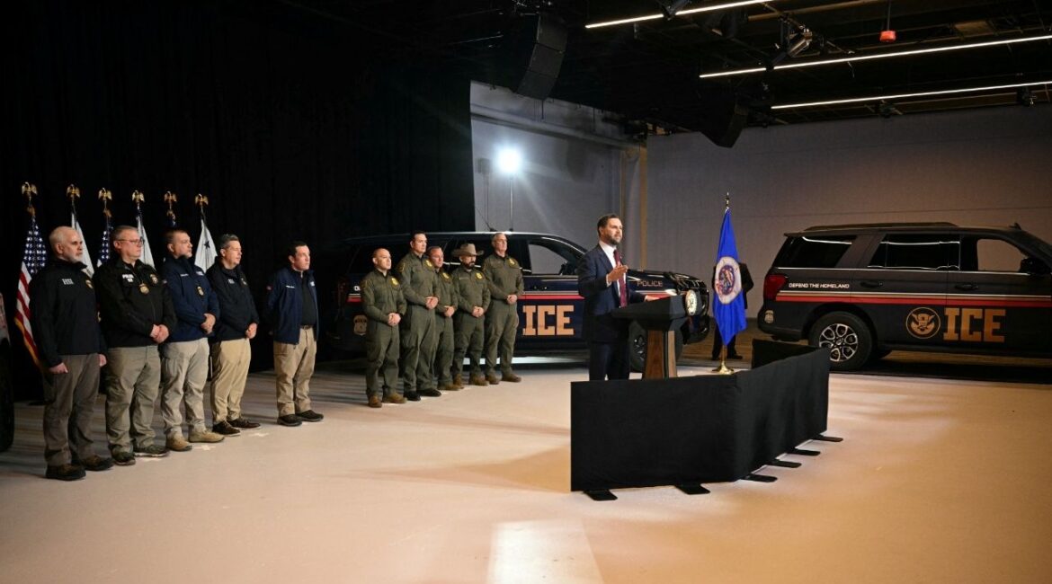 ICE vehicles sit in the background as federal immigration agents listen to U.S. Vice President JD Vance speak at Royalston Square in Minneapolis, Minnesota, U.S. January 22, 2026. (Jim Watson/Pool via Reuters)