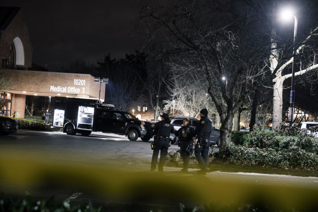 Police officers in the parking lot of a medical clinic in Portland, Oregon, where federal agents shot two people during a traffic stop, on Thursday, Jan. 8, 2026. The shooting in Portland was at least the 10th since September by federal agents who are part of the Trump administration’s immigration crackdown — and all involved people who were in their vehicles. (Jordan Gale/ The New York Times)