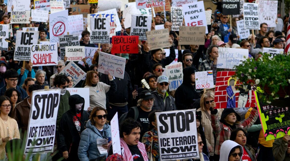 Image of protesters in San Antonio, Texas. Their signs say Stop ICE Terror Now