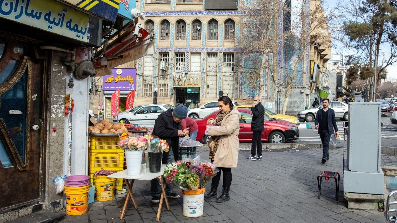 In a photograph taken on a government-led media tour on Wednesday, Jan. 21, 2026, a woman in Tehran shops in front of a mosque that was damaged during recent protests. President Donald Trump said late Thursday that a large naval force is heading to Iran, continuing his threats of U.S. military action against the government nearly a month after protests erupted across the country. (Arash Khamooshi/The New York Times)