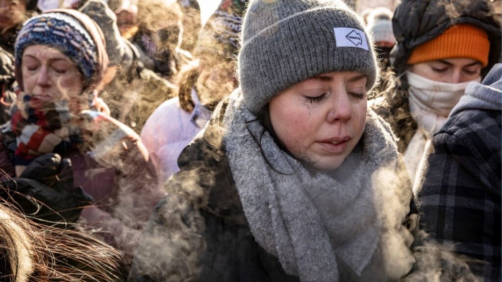 Kallen Bahl, a nurse, gathers with fellow health care providers and other mourners at the site in Minneapolis where Alex Pretti was shot and killed by federal immigration agents on Sunday, Jan. 25, 2026. (David Guttenfelder/The New York Times)