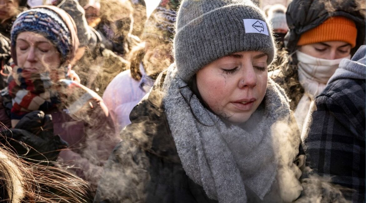 Kallen Bahl, a nurse, gathers with fellow health care providers and other mourners at the site in Minneapolis where Alex Pretti was shot and killed by federal immigration agents on Sunday, Jan. 25, 2026. (David Guttenfelder/The New York Times)
