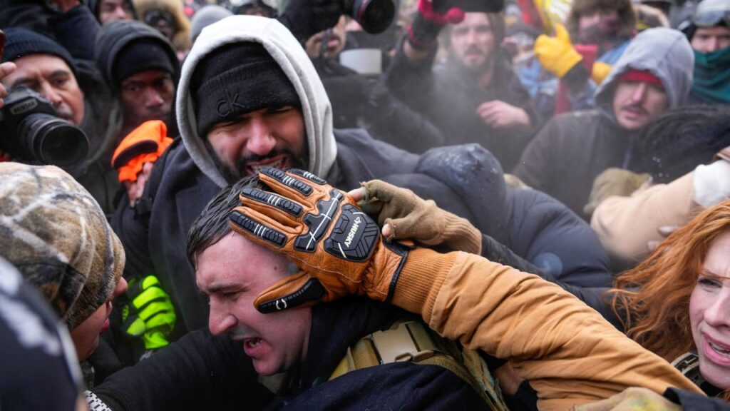 Image of conservative influencer Jake Lang surrounded by liberal counterprotesters in Minneapolis