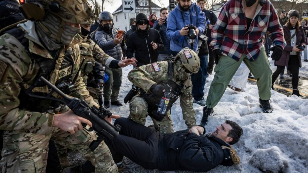 Members of the Border Patrol Tactical Unit shove a man to the ground as federal agents try to leave the scene of a shooting involving a federal immigration officer in Minneapolis, on Wednesday, Jan. 7, 2026. A federal immigration officer shot and killed a person in Minneapolis on Wednesday during an enforcement operation, the Department of Homeland Security said. (David Guttenfelder/The New York Times)