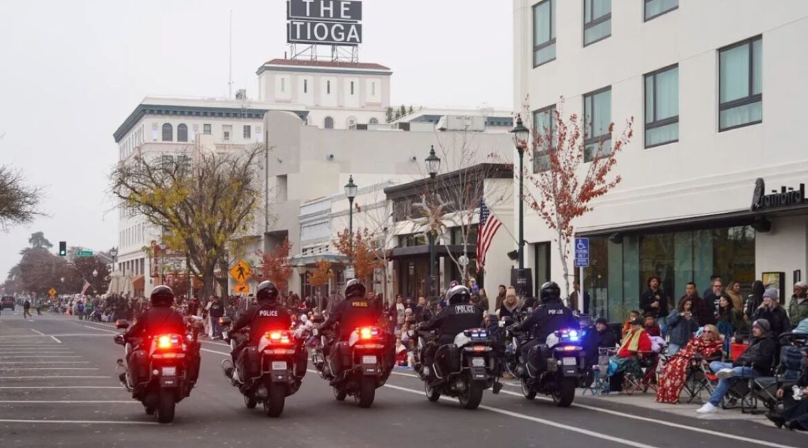Image of the Merced PD motorcycle unit leading a holiday parade on a winter day