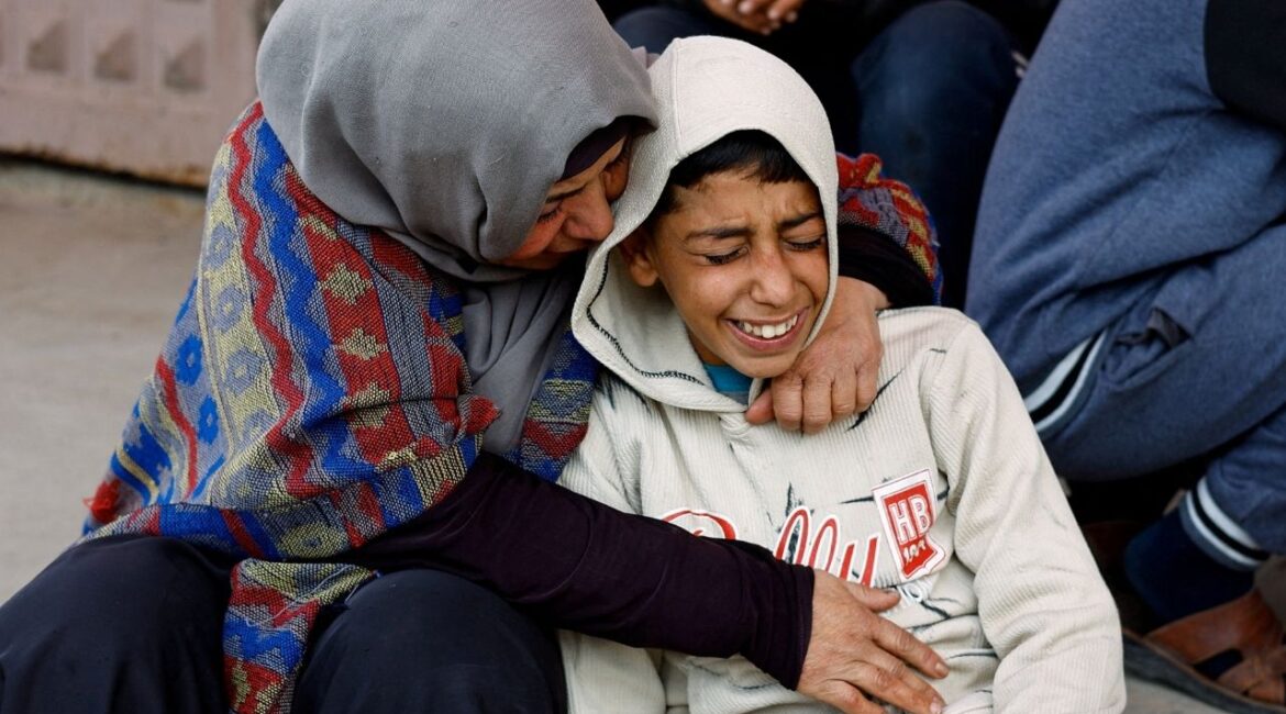 Mourners react during the funeral of Palestinians who, according to medics, were killed by Israeli strikes on Wednesday, at Al-Aqsa Martyrs Hospital, in Deir al-Balah, central Gaza Strip, January 21, 2026. (Reuters/Mahmoud Issa)