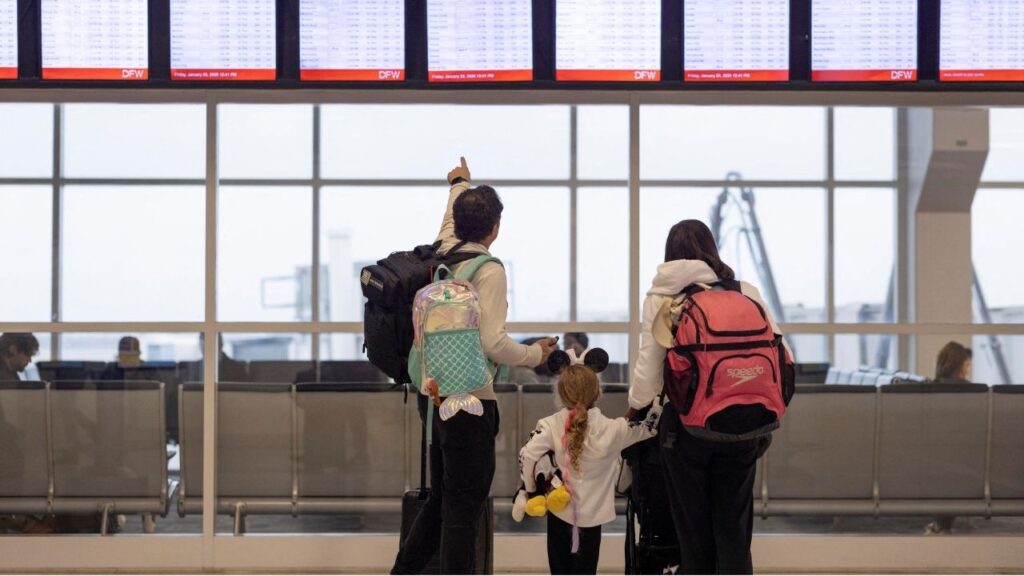 People check the flight tracker screens at the Dallas Fort Worth International Airport in Fort Worth, Texas, U.S., January 23, 2026. (Reuters/Alyssa Pointer)
