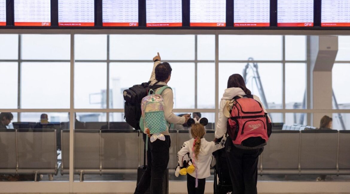 People check the flight tracker screens at the Dallas Fort Worth International Airport in Fort Worth, Texas, U.S., January 23, 2026. (Reuters/Alyssa Pointer)