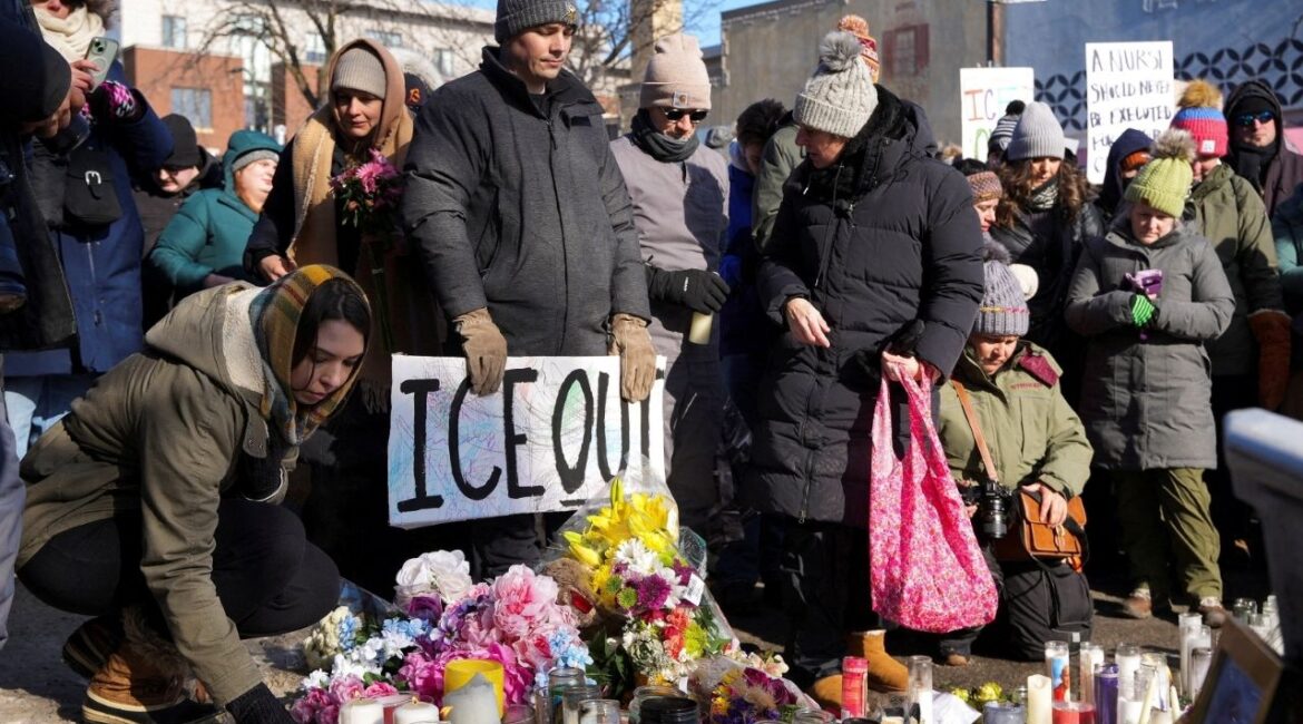 People gather at a makeshift memorial at the site where a man identified as Alex Pretti was fatally shot by federal immigration agents trying to detain him, in Minneapolis, Minnesota, U.S., January 25, 2026. (Reuters/Tim Evans)