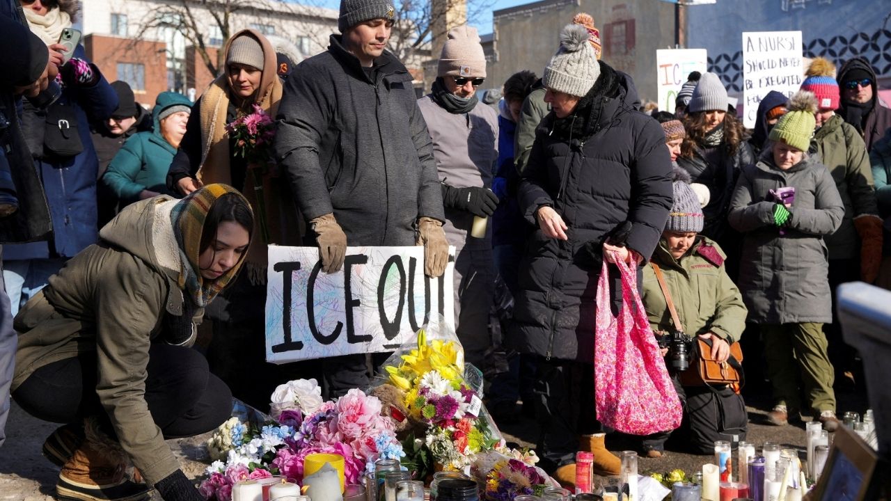 People gather at a makeshift memorial at the site where a man identified as Alex Pretti was fatally shot by federal immigration agents trying to detain him, in Minneapolis, Minnesota, U.S., January 25, 2026. (Reuters/Tim Evans)