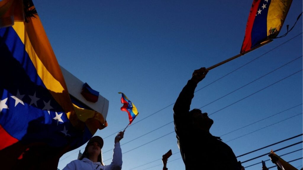 People holding Venezuelan flags react to the news after U.S. President Donald Trump said the U.S. has struck Venezuela and captured its President Nicolas Maduro, in Doral, Miami, Florida, U.S., January 3, 2026. REUTERS/Marco Bello