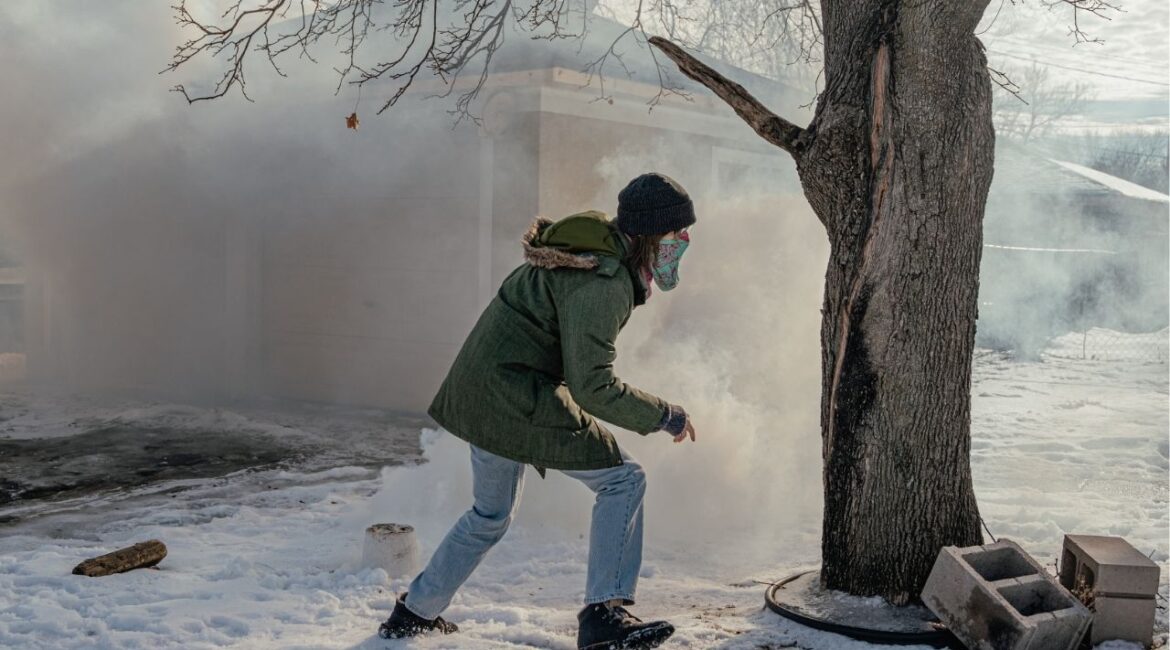 People in the community run from clouds of tear gas deployed by federal agents after federal immigration officers crashed into a vehicle in south Minneapolis, Jan. 12, 2026. (Jamie Kelter Davis/The New York Times)