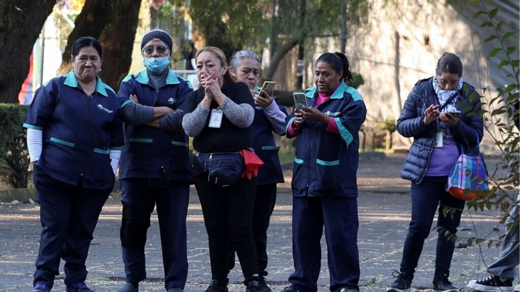 People stand after leaving a building following an earthquake, Mexico City, Mexico, January 2, 2026. (Reuters/Luis Cortes)