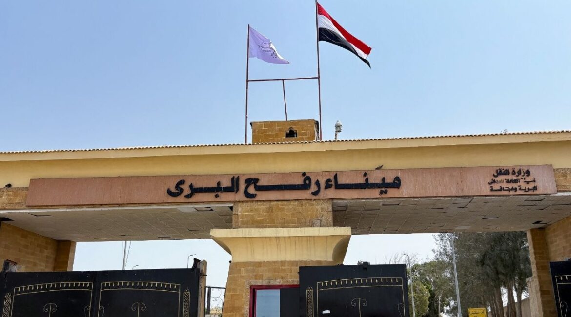 People stand at the Rafah border crossing between Egypt and the Gaza Strip, in Rafah, Egypt, August 11, 2025. (Reuters/Alexander Dziadosz)