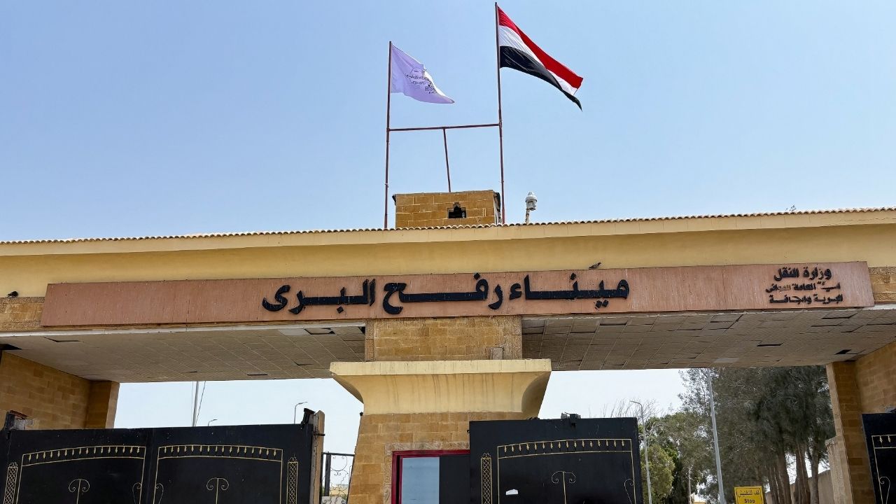 People stand at the Rafah border crossing between Egypt and the Gaza Strip, in Rafah, Egypt, August 11, 2025. (Reuters/Alexander Dziadosz)