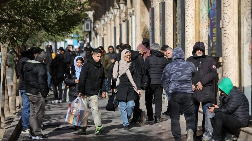 People walk past stores as the value of the Iranian Rial drops, in Tehran, Iran, December 30, 2025. (Reuters File)