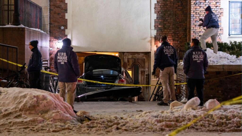 Poilice investigators on the scene after a man rammed his car at least four times into a rear entrance of the global headquarters of the Chabad-Lubavitch Orthodox Jewish movement in Brooklyn on Wednesday night, Jan. 29, 2026, according to the police and video of the crash. The driver was immediately arrested, there were no injuries, and the episode was being investigated as a hate crime, Police Commissioner Jessica Tisch said. (Dakota Santiago/The New York Times)