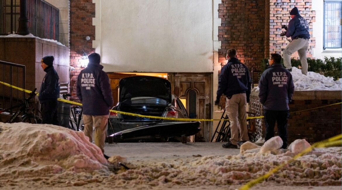Poilice investigators on the scene after a man rammed his car at least four times into a rear entrance of the global headquarters of the Chabad-Lubavitch Orthodox Jewish movement in Brooklyn on Wednesday night, Jan. 29, 2026, according to the police and video of the crash. The driver was immediately arrested, there were no injuries, and the episode was being investigated as a hate crime, Police Commissioner Jessica Tisch said. (Dakota Santiago/The New York Times)