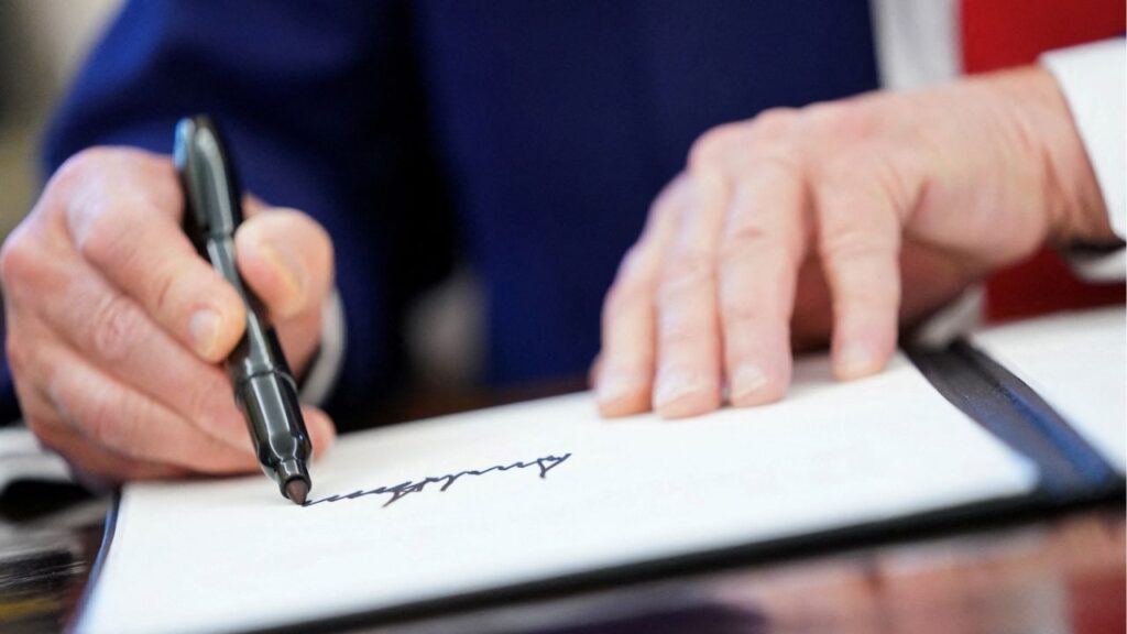 President Donald Trump writes his signature, as he signs executive orders and proclamations in the Oval Office at the White House in Washington, D.C., U.S., April 9, 2025. (Reuters File)