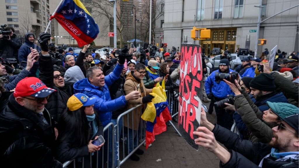 Protesters demonstrating for and against the U.S. capture of Nicolas Maduro argue from behind barricades across the street from the federal courthouse in lower Manhattan, where Nicolas Maduro, the ousted president of Venezuela, and his wife, Cilia Florez, are scheduled to be arraigned later on Monday, Jan. 5, 2026. Maduro and Flores are expected to face charges of drug trafficking and other crimes, two days after they were captured in a U.S. military raid in Caracas. (Karsten Moran/The New York Times)