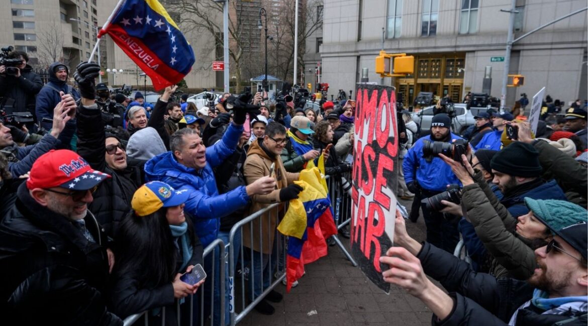 Protesters demonstrating for and against the U.S. capture of Nicolas Maduro argue from behind barricades across the street from the federal courthouse in lower Manhattan, where Nicolas Maduro, the ousted president of Venezuela, and his wife, Cilia Florez, are scheduled to be arraigned later on Monday, Jan. 5, 2026. Maduro and Flores are expected to face charges of drug trafficking and other crimes, two days after they were captured in a U.S. military raid in Caracas. (Karsten Moran/The New York Times)