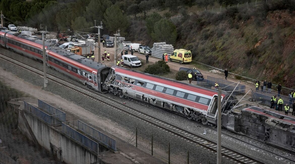 Rescuers with train cars on from a Iryo high-speed train that was involved in a Sunday crash with another train in Adamuz, Spain, on Monday, Jan. 19, 2026. The Spanish authorities were investigating the causes on Monday of a high-speed train crash in southern Spain that killed at least 39 people, and survivors described harrowing scenes of bodies thrown from mangled train cars. (Finbarr O’Reilly/The New York Times)