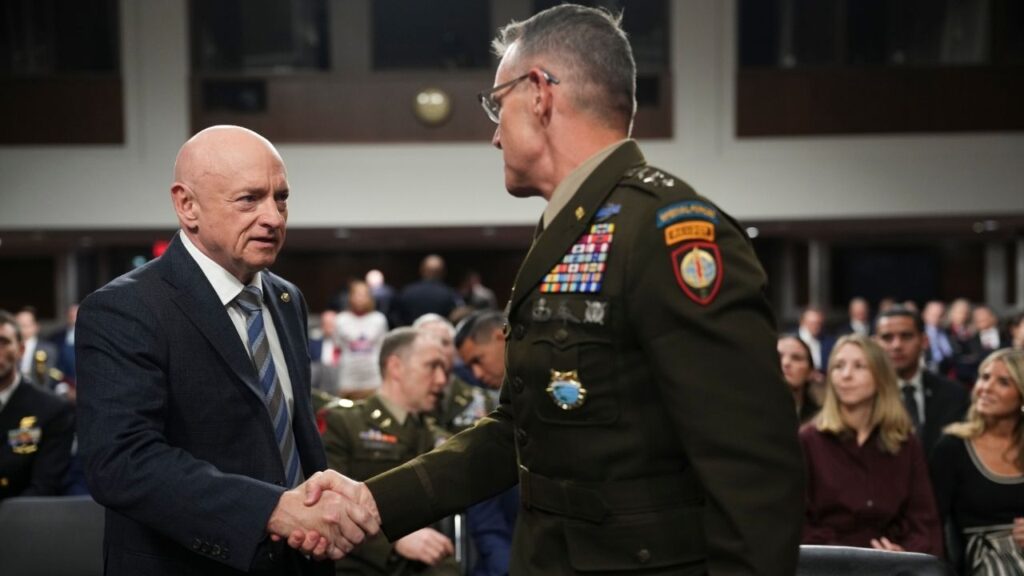 Sen. Mark Kelly (D-Ariz.) greets Lt. Gen. Joshua Rudd, President Trump’s nominee to lead the U.S. Cyber Command and the National Security Agency, before Rudd’s confirmation hearing with the Senate Armed Services Committee on Capitol Hill in Washington, on Thursday, Jan. 15, 2026. Senators are expected to ask Rudd about the operation in Venezuela. (Eric Lee/The New York Times)
