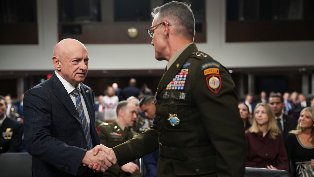 Sen. Mark Kelly (D-Ariz.) greets Lt. Gen. Joshua Rudd, President Trump’s nominee to lead the U.S. Cyber Command and the National Security Agency, before Rudd’s confirmation hearing with the Senate Armed Services Committee on Capitol Hill in Washington, on Thursday, Jan. 15, 2026. Senators are expected to ask Rudd about the operation in Venezuela. (Eric Lee/The New York Times)