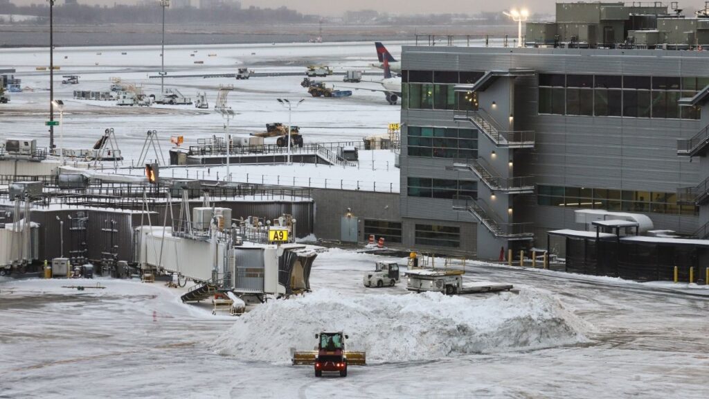 Snow is plowed on the tarmac at John F. Kennedy International Airport in New York, Dec. 27, 2025. Airlines and airports on Friday, Jan. 23, 2026, were preparing for widespread disruptions this weekend as a powerful storm threatened to blanket large parts of the country in ice and snow. (Gabe Castro-Root/The New York Times)