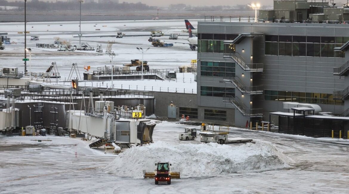 Snow is plowed on the tarmac at John F. Kennedy International Airport in New York, Dec. 27, 2025. Airlines and airports on Friday, Jan. 23, 2026, were preparing for widespread disruptions this weekend as a powerful storm threatened to blanket large parts of the country in ice and snow. (Gabe Castro-Root/The New York Times)