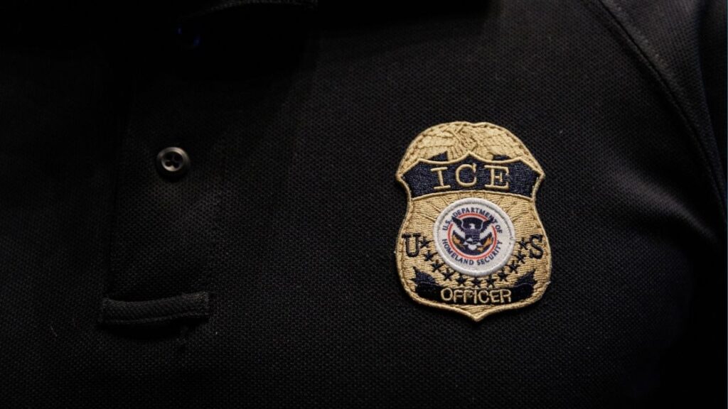 The badge of a U.S. Immigration and Customs Enforcement (ICE) is embroidered on a polo shirt of an ICE employee in Arlington, Texas, U.S. August 26, 2025. REUTERS/Shelby Tauber
