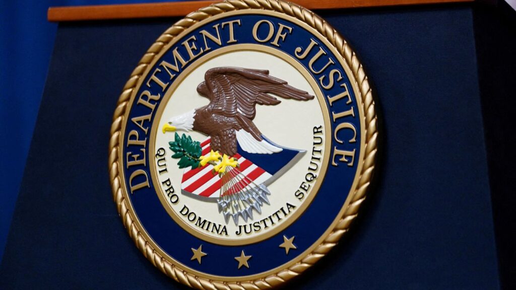 The seal of the U.S. Justice Department is seen on the podium in the Department's headquarters briefing room in Washington, January 24, 2023. (Reuters/Kevin Lamarque/File Photo)