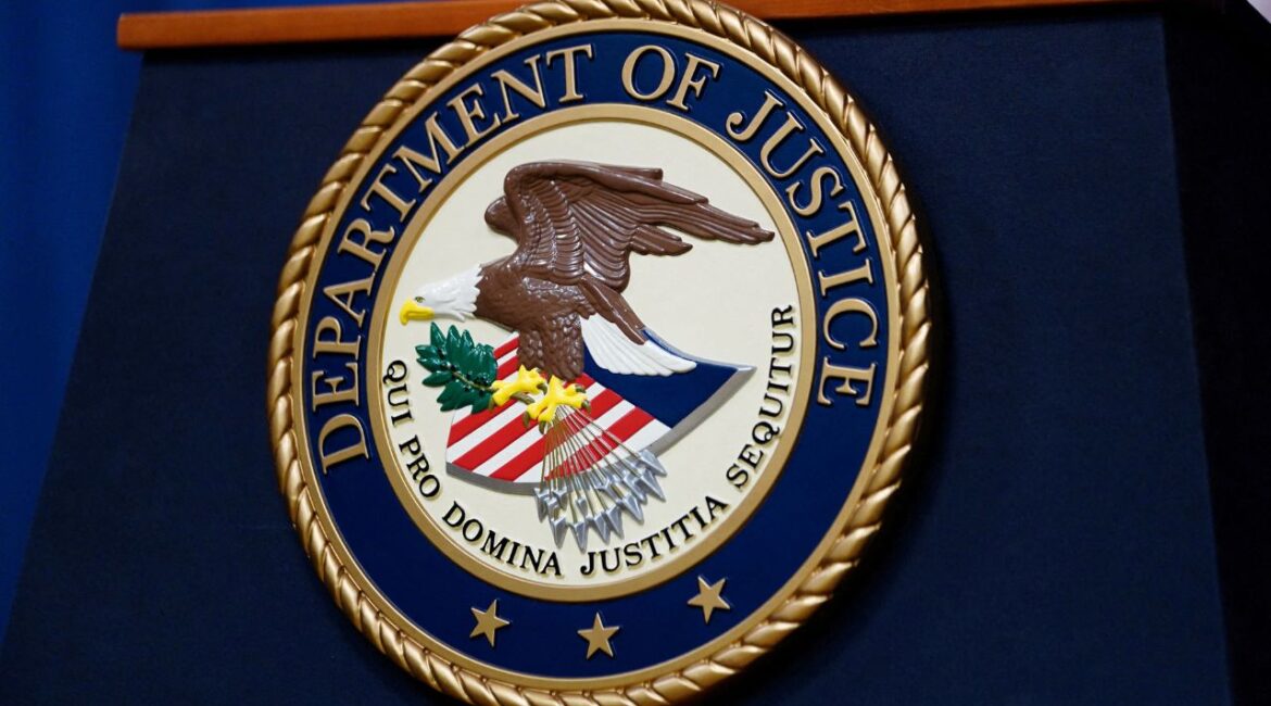 The seal of the U.S. Justice Department is seen on the podium in the Department's headquarters briefing room in Washington, January 24, 2023. (Reuters/Kevin Lamarque/File Photo)