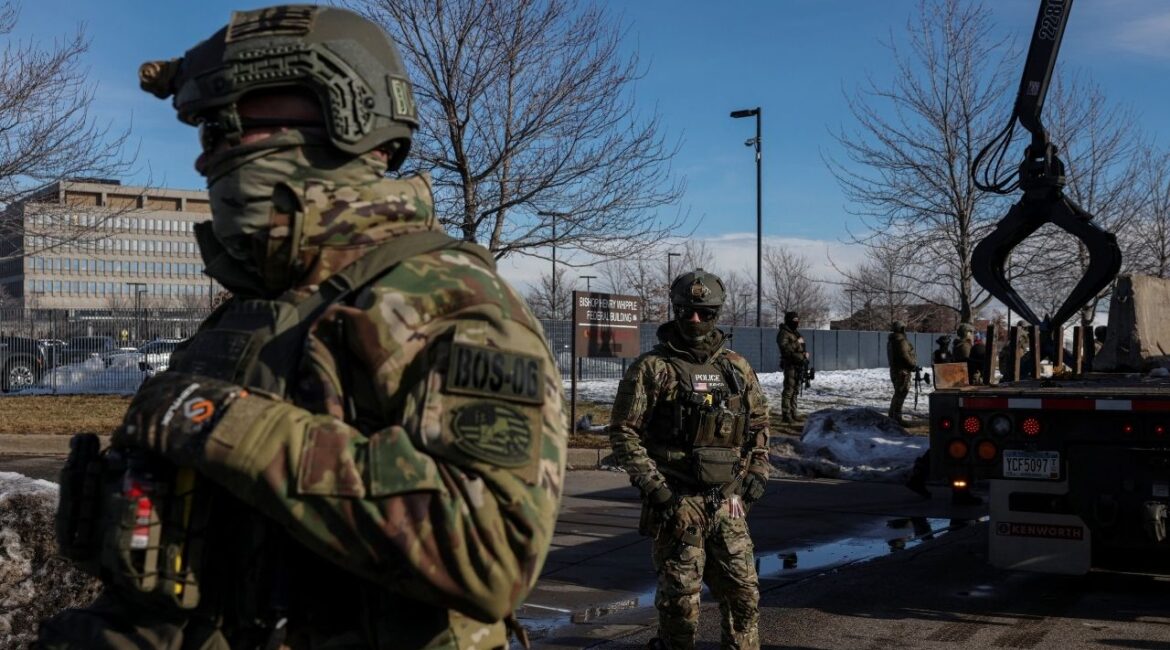 U.S. Immigration and Customs Enforcement (ICE) agents stand guard during protests against increased immigration enforcement and the fatal shooting of Renee Nicole Good by an ICE agent, in Minneapolis, Minnesota, U.S., January 9, 2026. REUTERS/Tyrone Siu