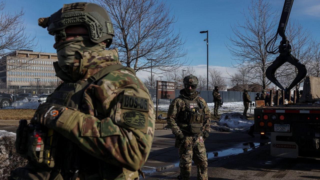 U.S. Immigration and Customs Enforcement (ICE) agents stand guard during protests against increased immigration enforcement and the fatal shooting of Renee Nicole Good by an ICE agent, in Minneapolis, Minnesota, U.S., January 9, 2026. REUTERS/Tyrone Siu