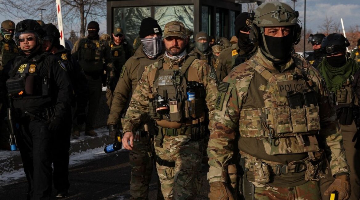 U.S. Immigration and Customs Enforcement (ICE) agents stand guard outside the Bishop Henry Whipple Federal Building during a demonstration against increased immigration enforcement, days after a U.S. Immigration and Customs Enforcement (ICE) agent fatally shot Renee Nicole Good, in Minneapolis, Minnesota, U.S., January 10, 2026. (Reuters/Tyrone Siu)