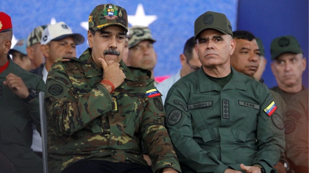 Venezuela's President Nicolas Maduro sits with Defence Minister Vladimir Padrino Lopez during a rally against a possible escalation of U.S. actions toward the country, at Fort Tiuna military base in Caracas, Venezuela, November 25, 2025. REUTERS/Leonardo Fernandez Viloria