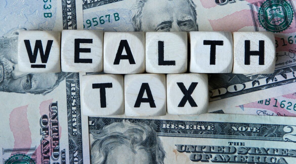 The words "Wealth Tax" superimposed on American paper currency