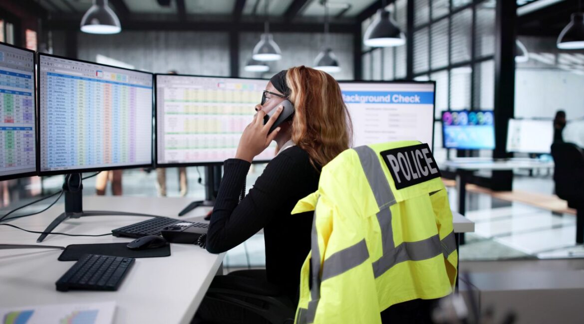 Image of African American police dispatcher talking on the phone