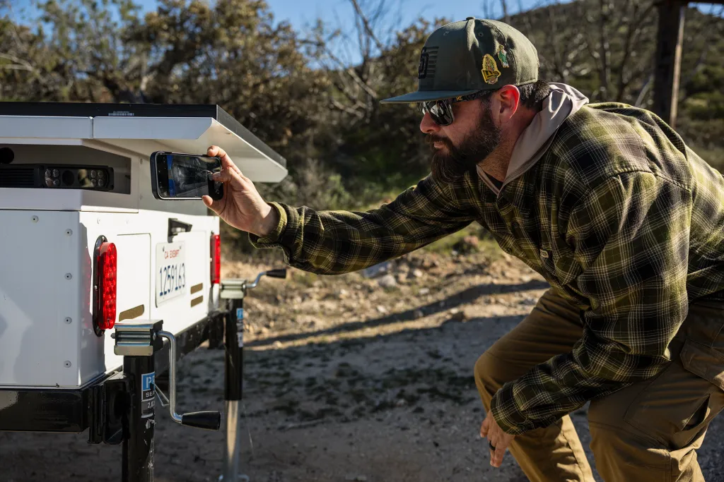 Image of a man photographing a Border Patrol automated license plate reader 