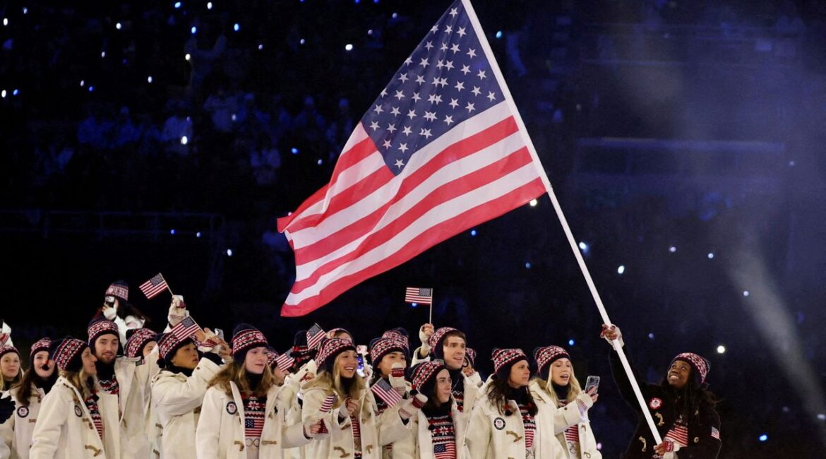 Image of the US Winter Olympic team with an American flag at opening ceremonies