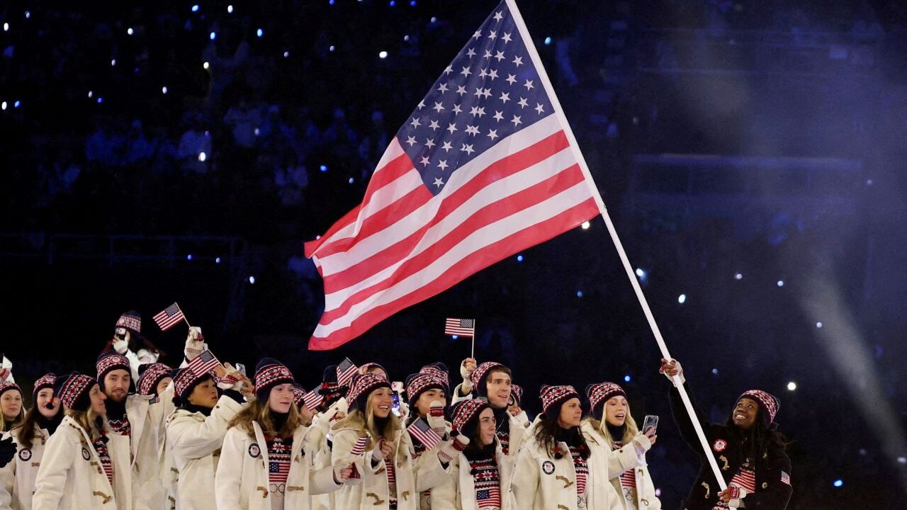 Image of the US Winter Olympic team with an American flag at opening ceremonies