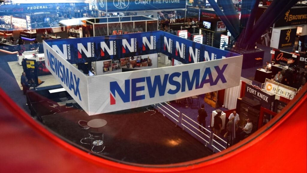 A Newsmax booth broadcasts as attendees try out the guns on display at the National Rifle Association (NRA) annual convention in Houston, Texas, U.S. May 29, 2022. (Reuters/Callaghan O'Hare)